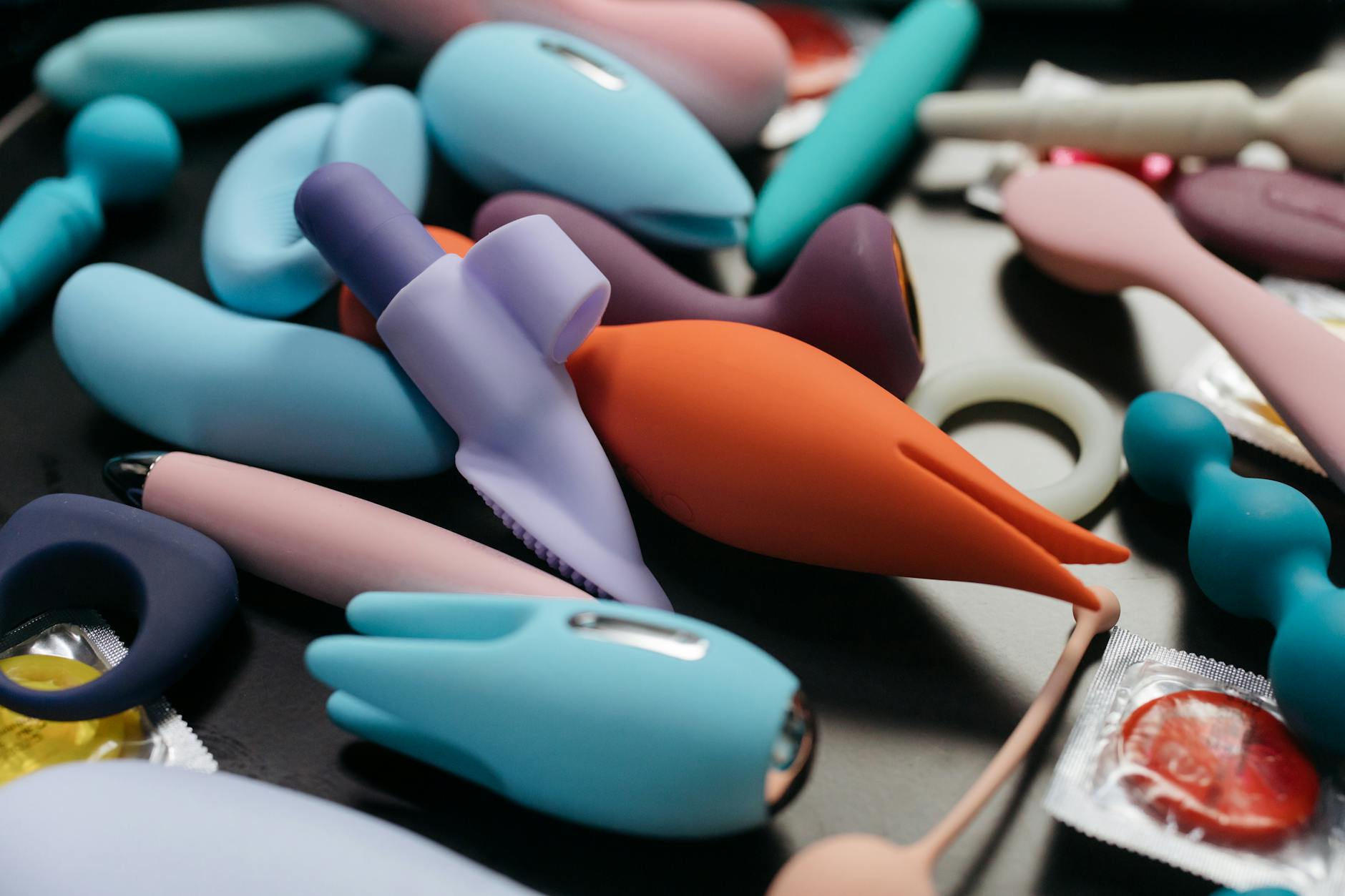 A blue silicone vibrator held in hand, representing renewed pleasure and sensitivity recovery